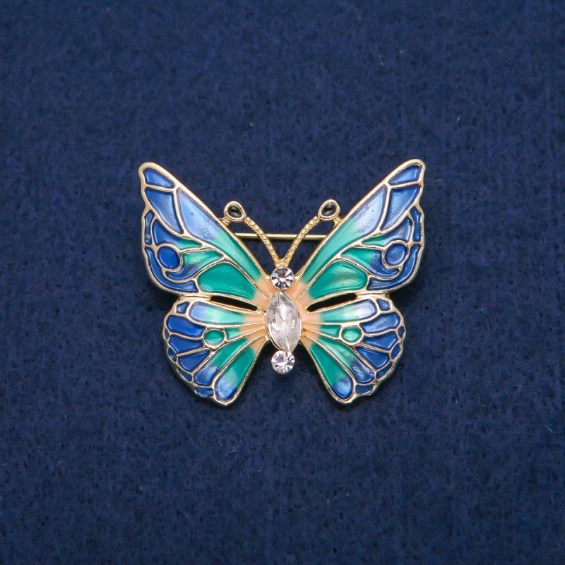 Broche Borboleta com cristais brancos e esmalte multicolor, metal dourado 31x37mm